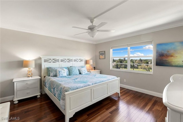 bedroom featuring baseboards, dark wood finished floors, a ceiling fan, and ornamental molding