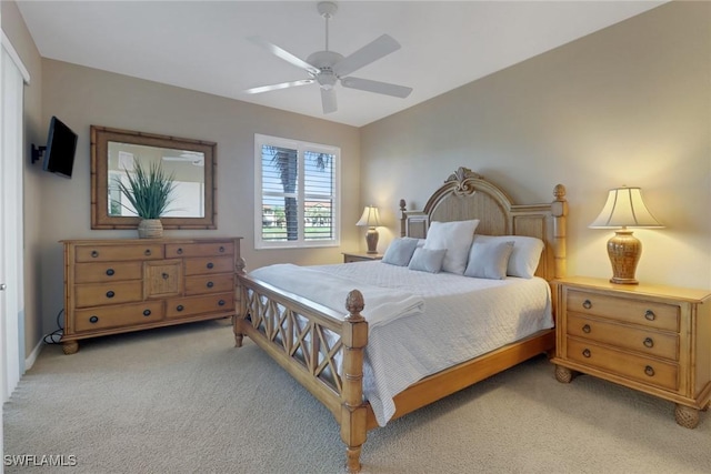 bedroom featuring a ceiling fan and light colored carpet