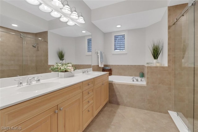 bathroom with a sink, tile patterned floors, a stall shower, and double vanity