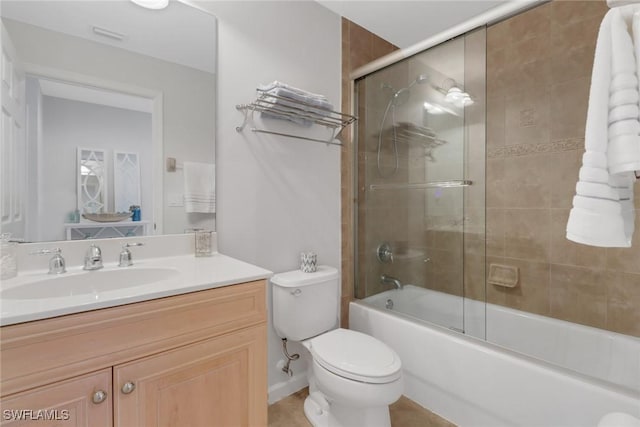 bathroom featuring vanity, shower / bath combination with glass door, and toilet