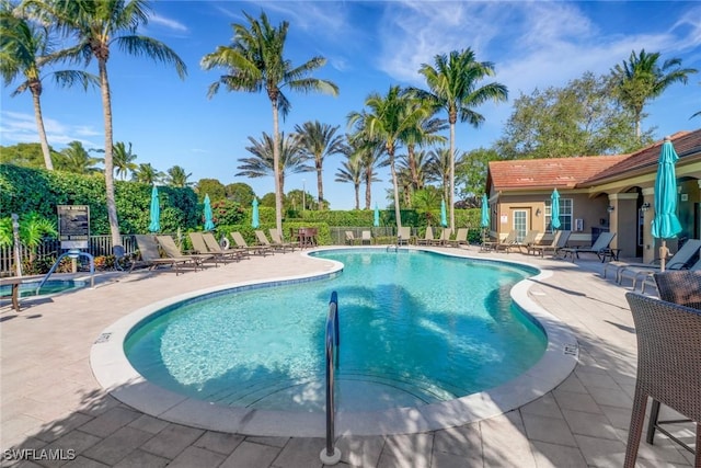 pool with fence and a patio area