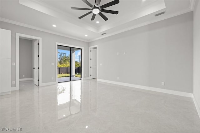 unfurnished room with recessed lighting, a tray ceiling, baseboards, and ornamental molding