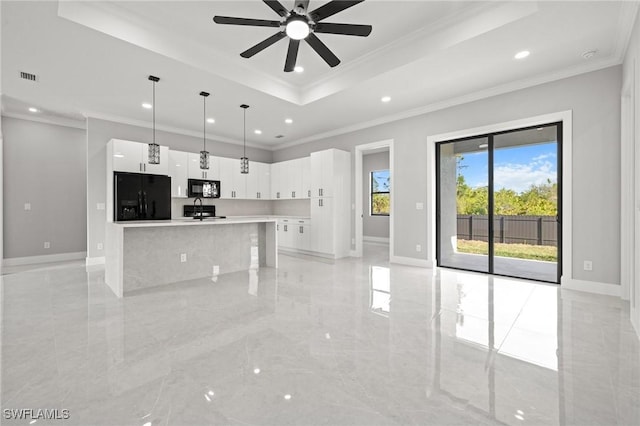 kitchen with visible vents, black appliances, baseboards, a tray ceiling, and white cabinetry