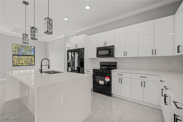 kitchen with ornamental molding, light stone counters, hanging light fixtures, black appliances, and a sink