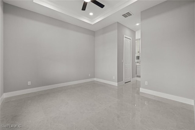 empty room with baseboards, visible vents, recessed lighting, ceiling fan, and a raised ceiling