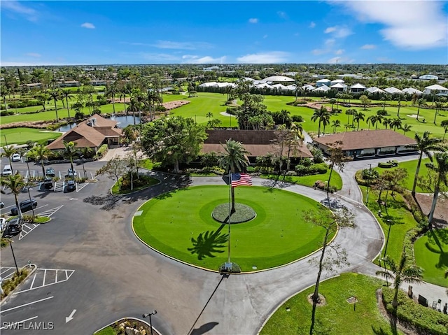 drone / aerial view featuring view of golf course and a residential view