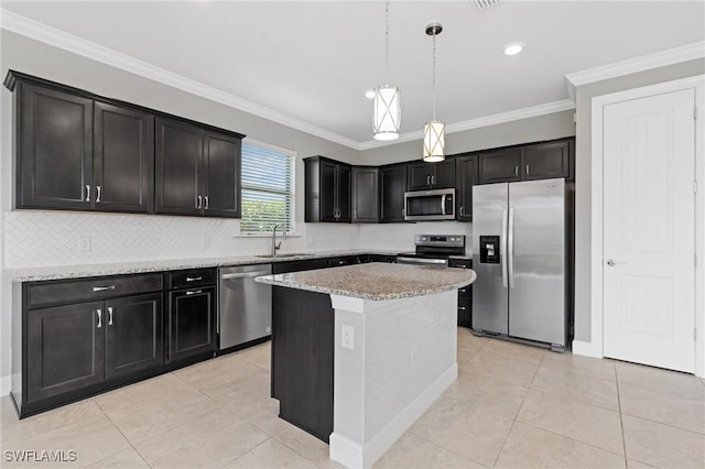 kitchen with a sink, decorative light fixtures, stainless steel appliances, light tile patterned flooring, and crown molding