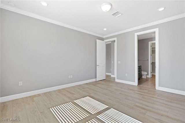 unfurnished bedroom featuring visible vents, baseboards, ornamental molding, and light wood finished floors