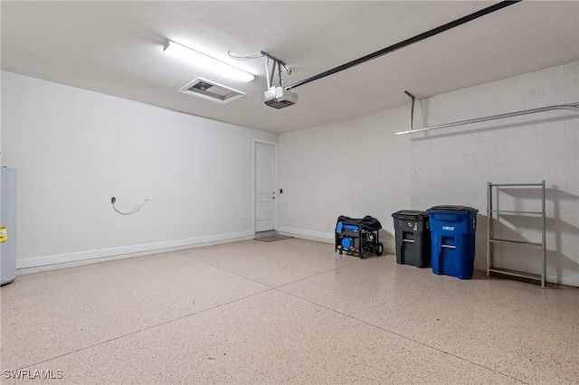 garage featuring a garage door opener, baseboards, and electric water heater