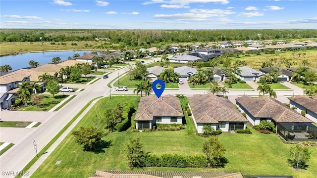 drone / aerial view with a residential view and a water view