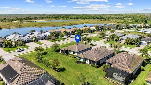 drone / aerial view with a residential view and a water view