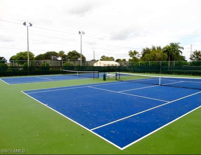 view of tennis court with fence