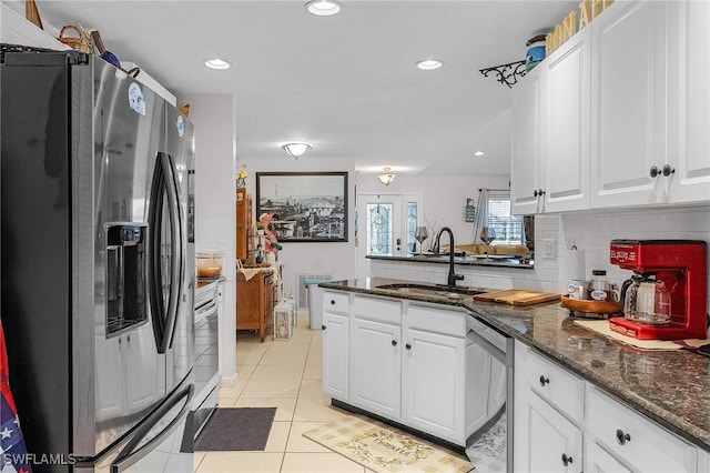 3319 Surfside Blvd, Cape Coral, FL 33914 - kitchen featuring a sink, a peninsula, white cabinets, and stainless steel appliances