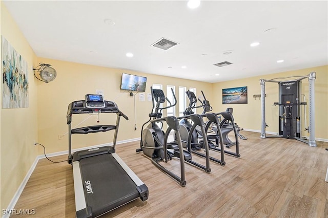 exercise room featuring recessed lighting, baseboards, visible vents, and light wood-type flooring