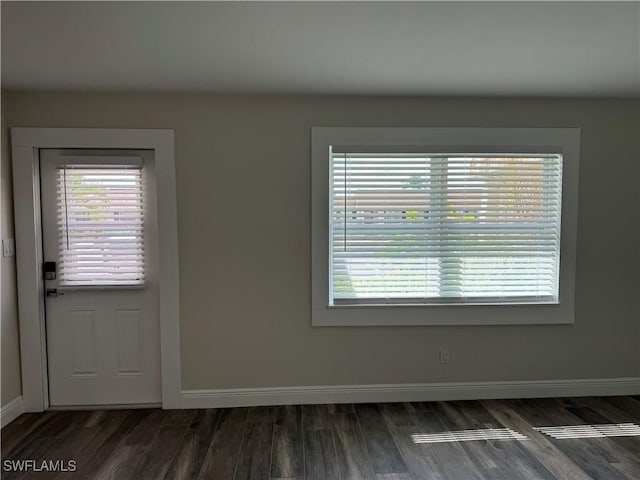 interior space featuring baseboards and wood finished floors