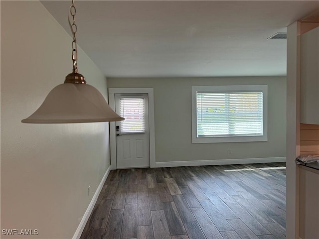 interior space featuring visible vents, baseboards, and wood finished floors