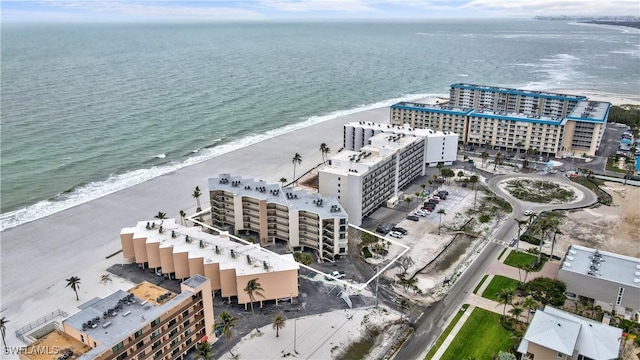 drone / aerial view with a beach view, a view of city, and a water view