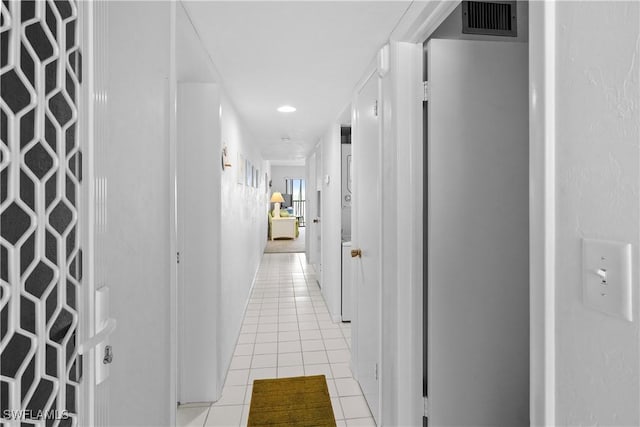 corridor featuring light tile patterned flooring and visible vents