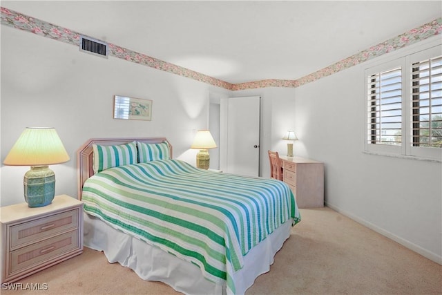 bedroom with visible vents, carpet, and baseboards