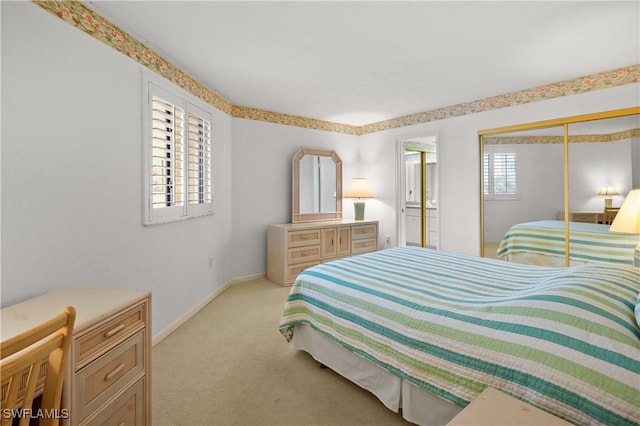 bedroom featuring baseboards, light carpet, and a closet