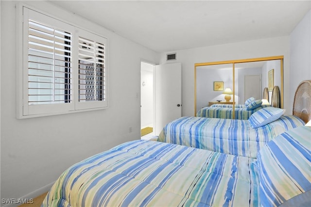 bedroom with a closet and visible vents