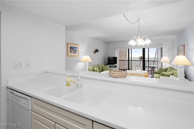 kitchen featuring a sink, light countertops, open floor plan, and white dishwasher