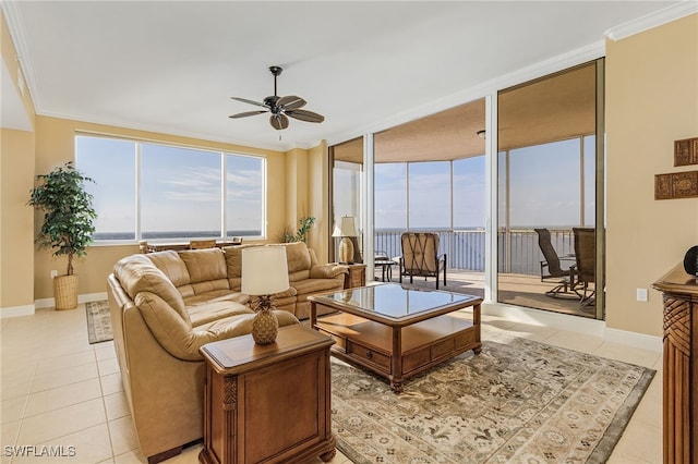 living area featuring plenty of natural light, light tile patterned flooring, a ceiling fan, and ornamental molding