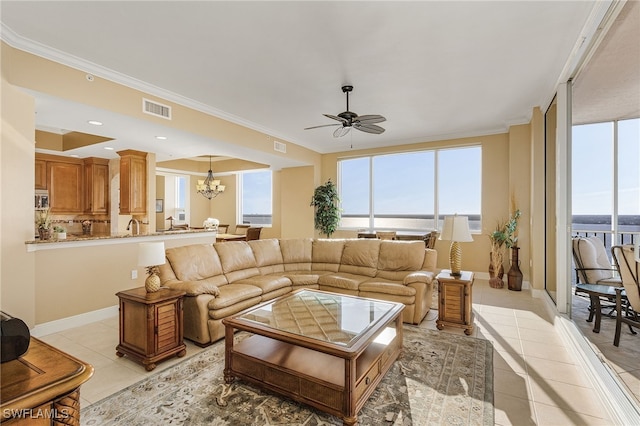 living area featuring a wealth of natural light, visible vents, and ornamental molding