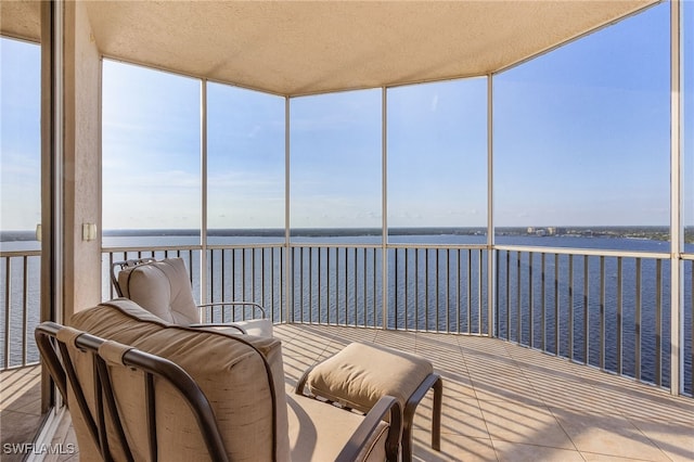 sunroom / solarium featuring a water view