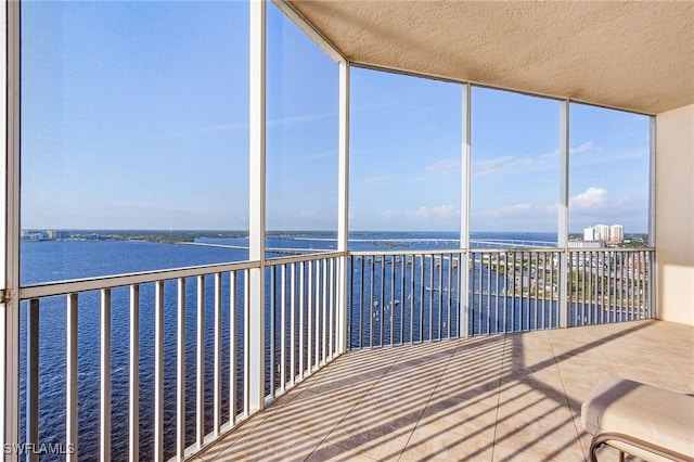 unfurnished sunroom with a water view