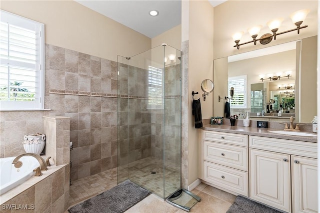 6849 Il Regalo Cir, Naples, FL 34109 - bathroom with vanity, tiled shower, tile patterned flooring, a garden tub, and a wealth of natural light