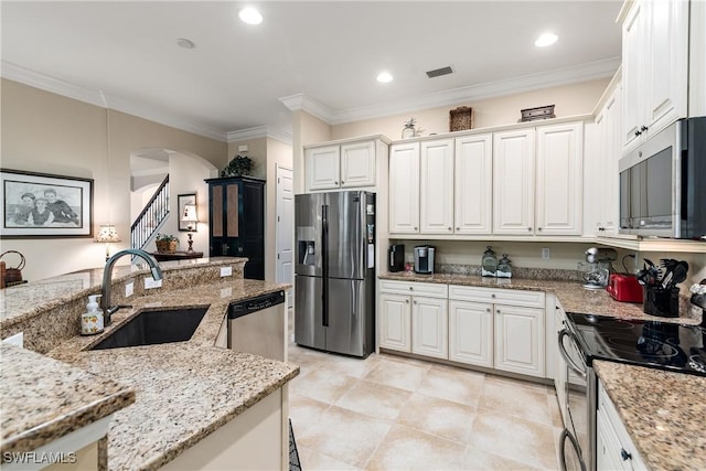 6849 Il Regalo Cir, Naples, FL 34109 - kitchen with visible vents, crown molding, arched walkways, stainless steel appliances, and a sink