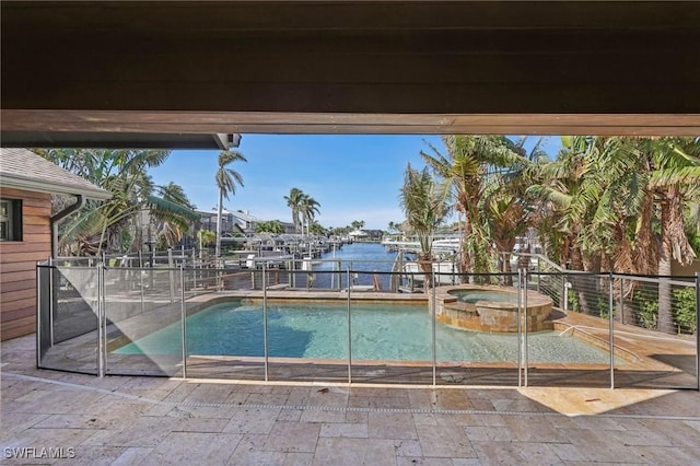 view of pool featuring a pool with connected hot tub and a water view