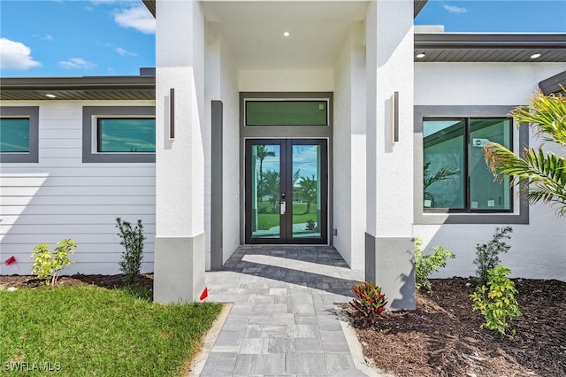 doorway to property with french doors and stucco siding