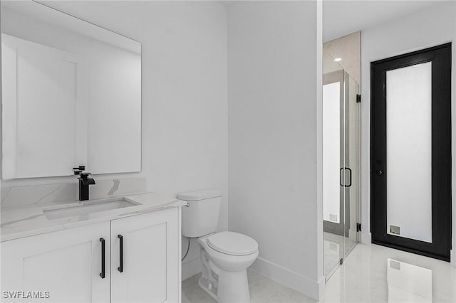 full bathroom featuring toilet, marble finish floor, a stall shower, baseboards, and vanity