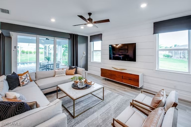 living room featuring visible vents, light wood finished floors, recessed lighting, ceiling fan, and crown molding