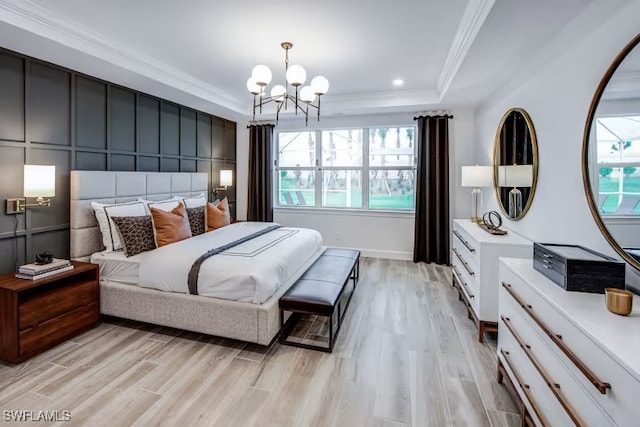 bedroom with light wood finished floors, a tray ceiling, recessed lighting, crown molding, and a notable chandelier