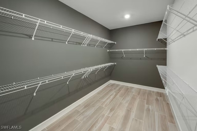 spacious closet featuring wood tiled floor