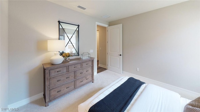 bedroom with light carpet, visible vents, and baseboards