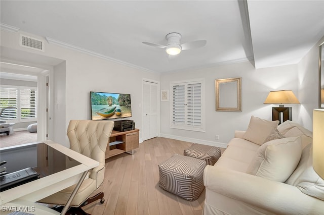 office with light wood-type flooring, visible vents, ceiling fan, and ornamental molding