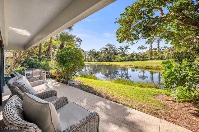 view of patio featuring outdoor dining area and a water view