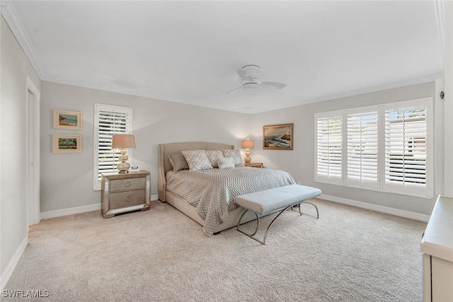 bedroom with crown molding, carpet flooring, a ceiling fan, and baseboards