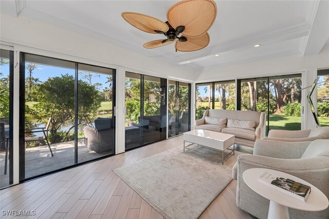 sunroom / solarium with beamed ceiling and a ceiling fan