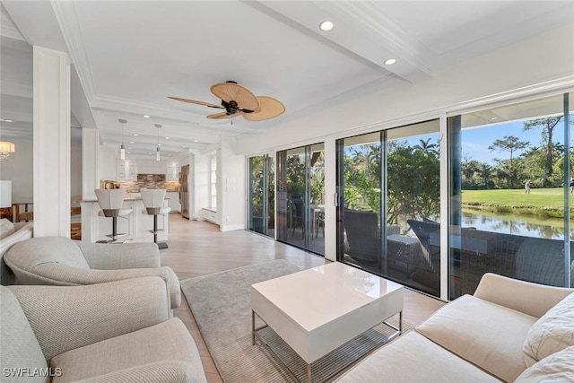 living room with recessed lighting, beamed ceiling, plenty of natural light, and a ceiling fan