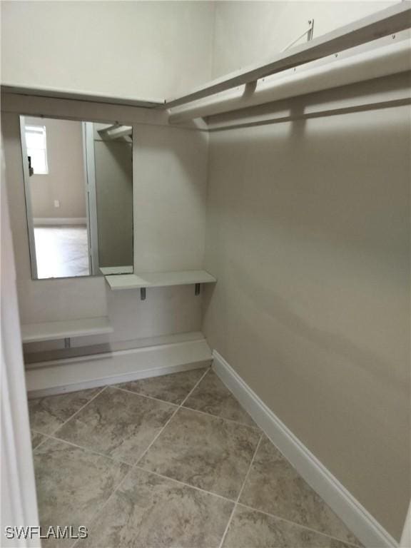 spacious closet featuring tile patterned floors