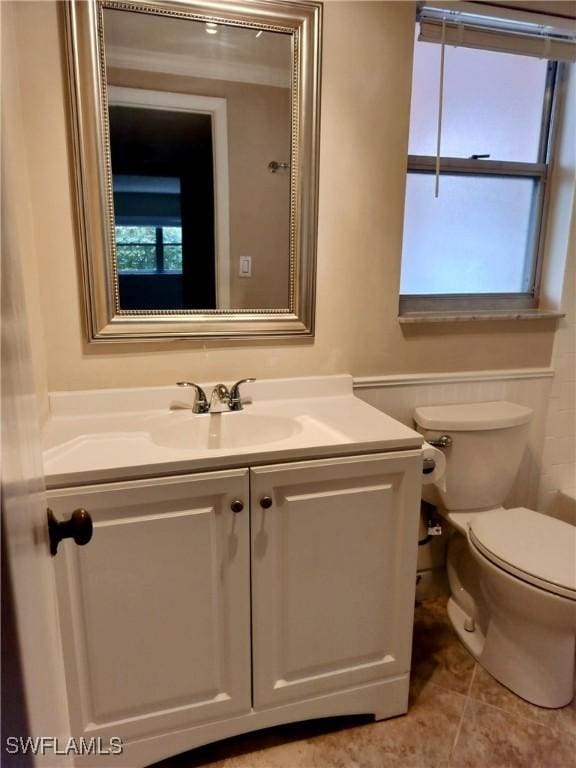 bathroom featuring tile patterned floors, toilet, and vanity