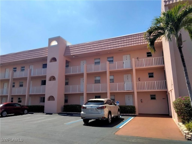 view of property featuring uncovered parking