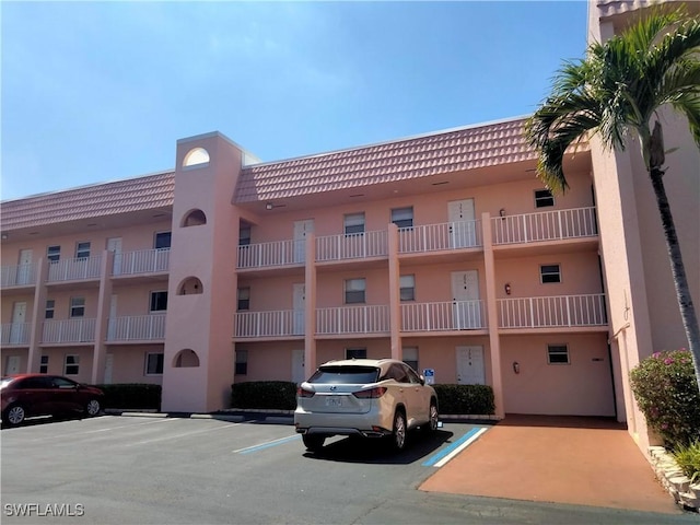 view of building exterior with uncovered parking