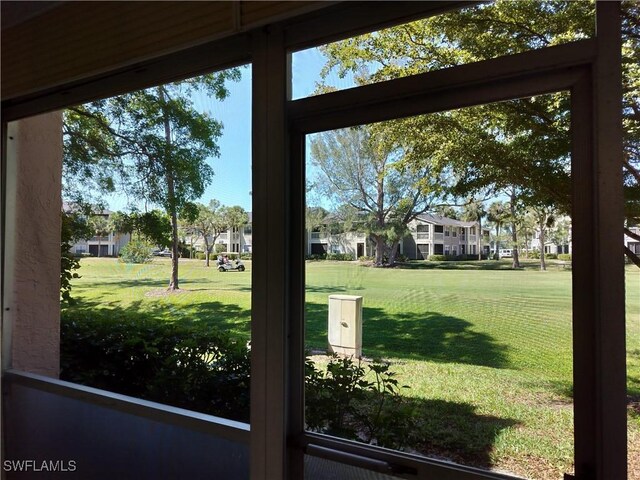 180 Turtle Lake Ct Unit 105, Naples, FL 34105 - view of green lawn featuring a residential view