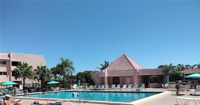 180 Turtle Lake Ct Unit 105, Naples, FL 34105 - community pool featuring a patio area
